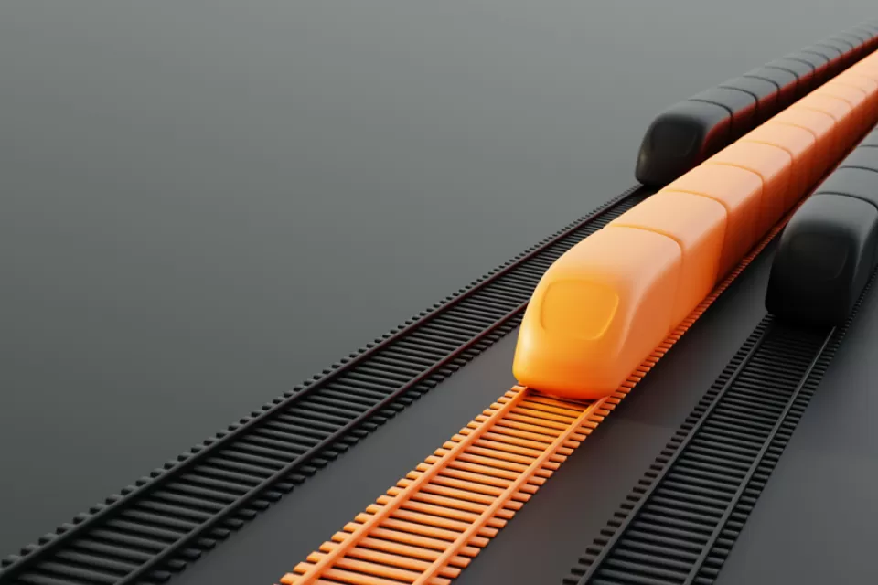 A conceptual rendering of three high-speed rail trains. The middle train is orange; the other two are black.